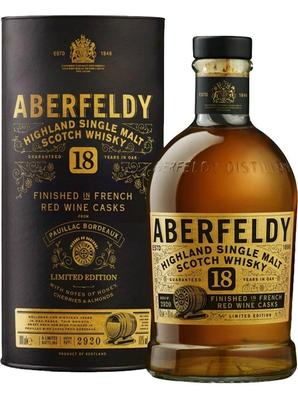 Product photography of Aberfeldy 18 Year Old Highland Single Malt Scotch Whisky from Scotland in a striking black and gold limited edition bottle and box, finished in French Red Wine Casks from Paulliac Bordeaux, with aromatic notes of honey, cherries, and almonds