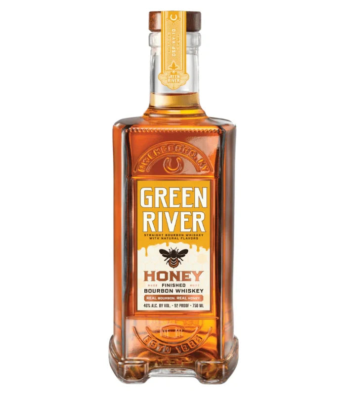 Photograph of a Green River Honey Finished Bourbon Whiskey bottle from Owensboro Kentucky, showcasing its amber liquid, a prominent yellow label with a black bee illustration for Honey, and embossed details including a horseshoe and ESTD 1885