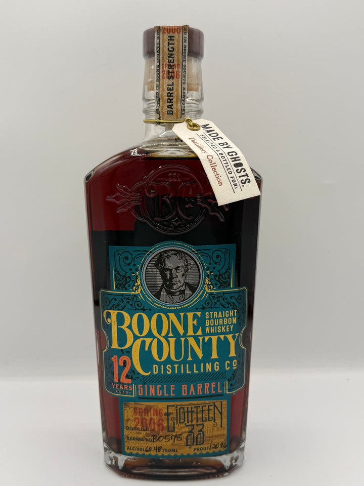 Product photograph of a Boone County 12 Years Single Barrel Straight Bourbon Whiskey bottle from Boone County Kentucky, showcasing its dark amber liquid, a vibrant teal and gold label featuring a man's portrait, and two neck tags indicating Barrel Strength 2006 Spring 2018 and Made by Ghosts