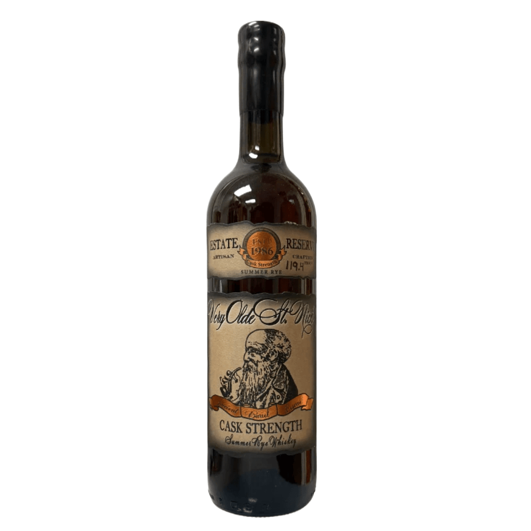 Photograph of a Very Olde St. Nick Cask Strength Summer Rye Whiskey bottle featuring a beige label with a bearded man smoking a pipe, a black wax-dipped cap, and "Est 1986" and "119.4 Proof" text