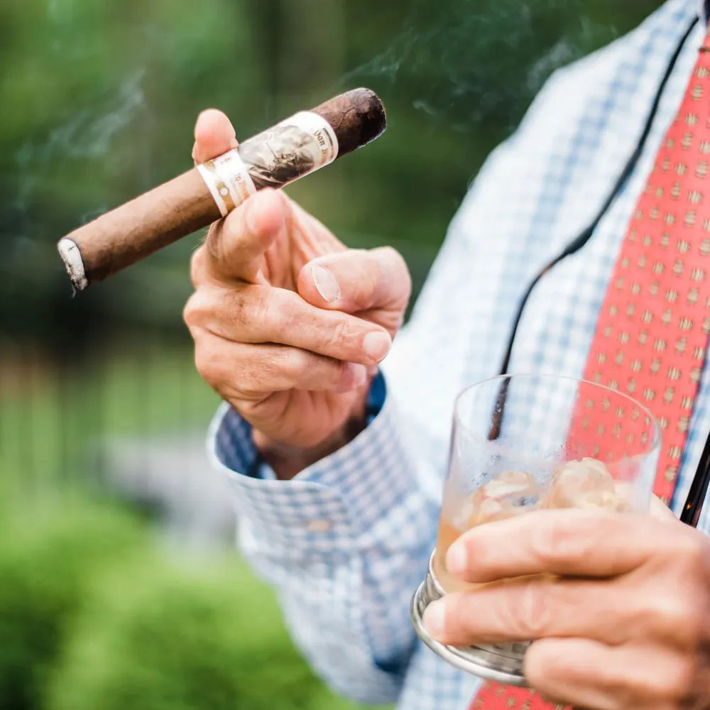 Individual Pappy Van Winkle Barrel Fermented Churchill cigar held alongside a glass of bourbon, showcasing the perfect pairing of premium cigars and whiskey.