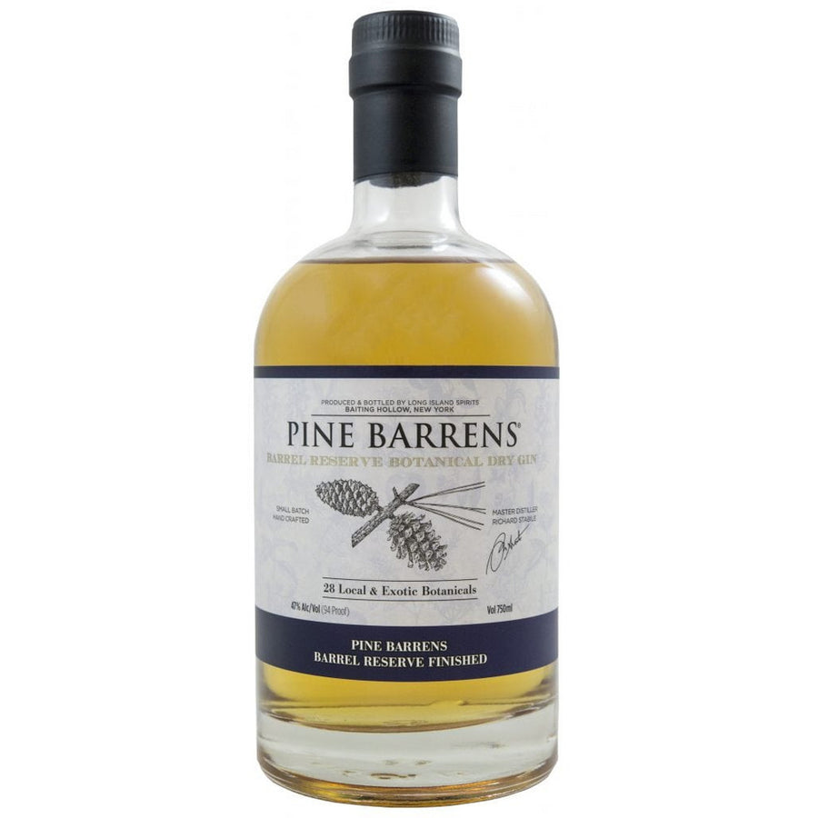 Product image by Long Island Spirits of a Pine Barrens Barrel Reserve Botanical Dry Gin bottle from Baiting Hollow New York, featuring a warm amber liquid, a black cap, and a label with a pine cone illustration and "28 Local & Exotic Botanicals" details